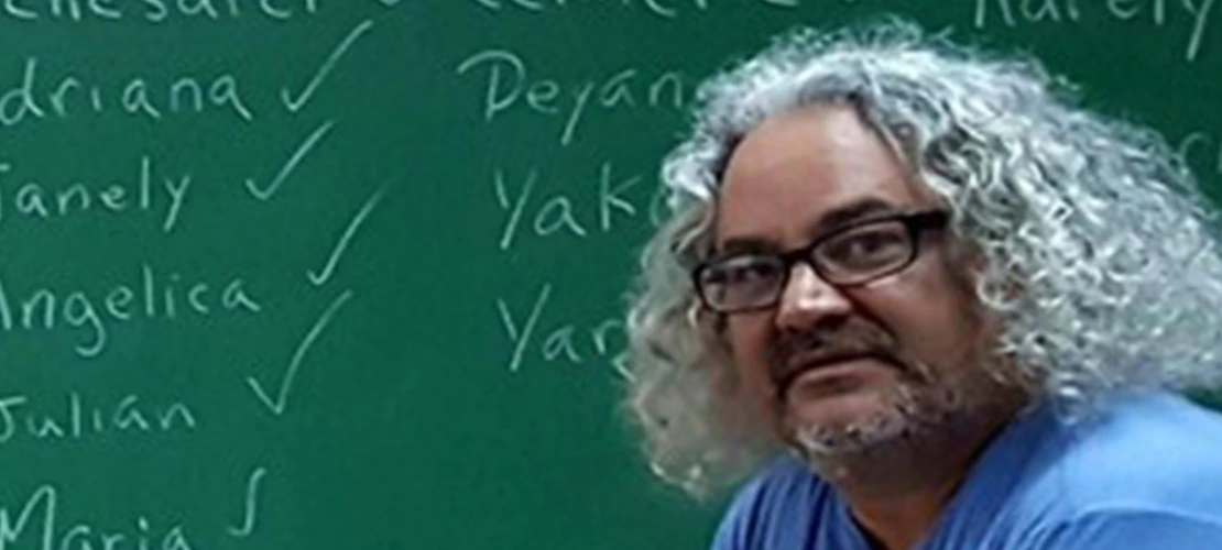 dr julio cammarota in front of a chalk board