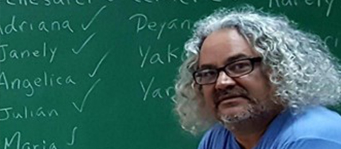 dr julio cammarota in front of a chalk board