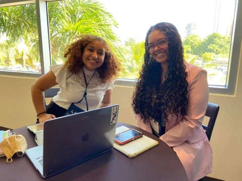 two female sitting at a table